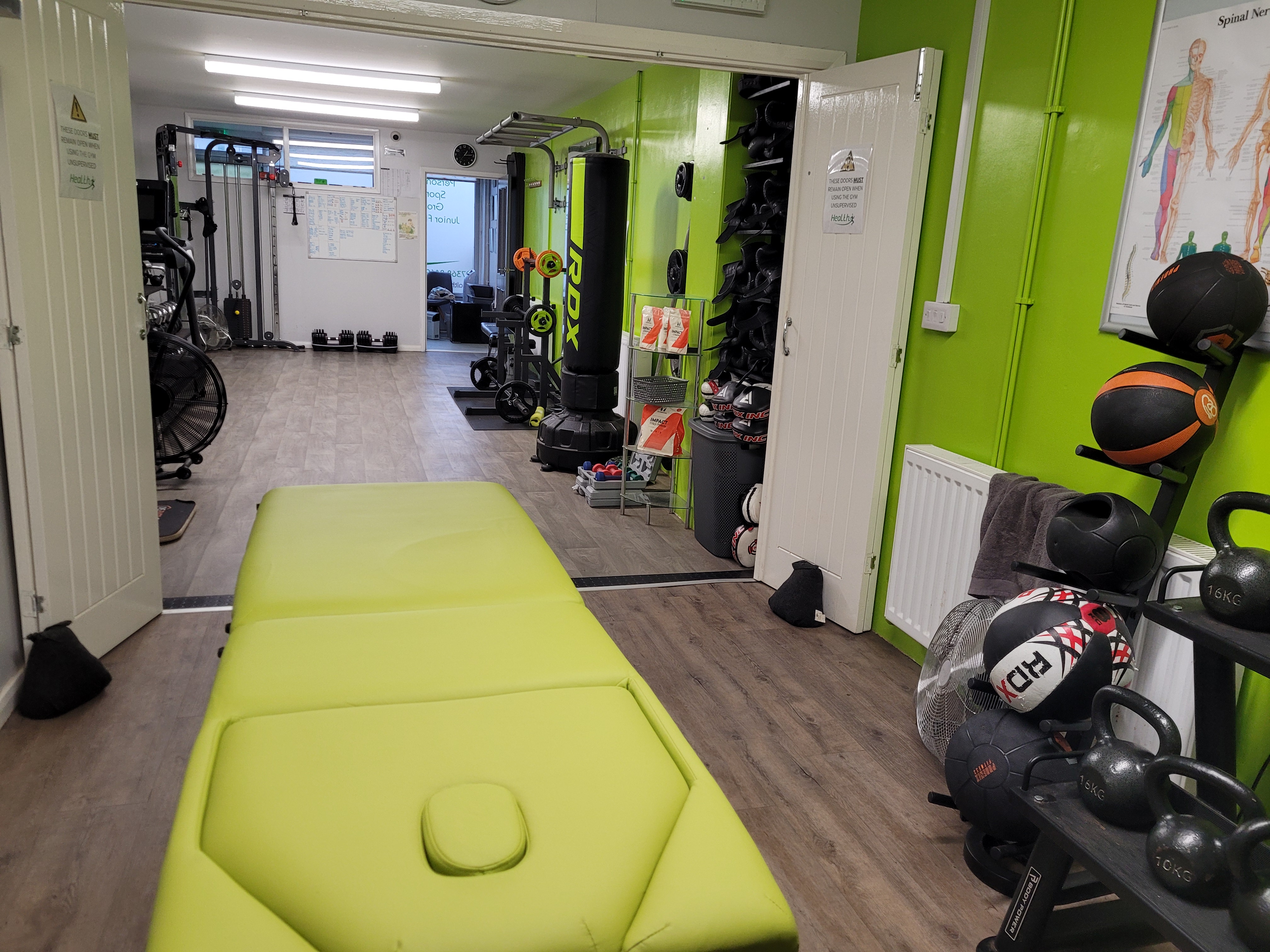 Physiotherapy clinic interior with treatment couch and gym equipment