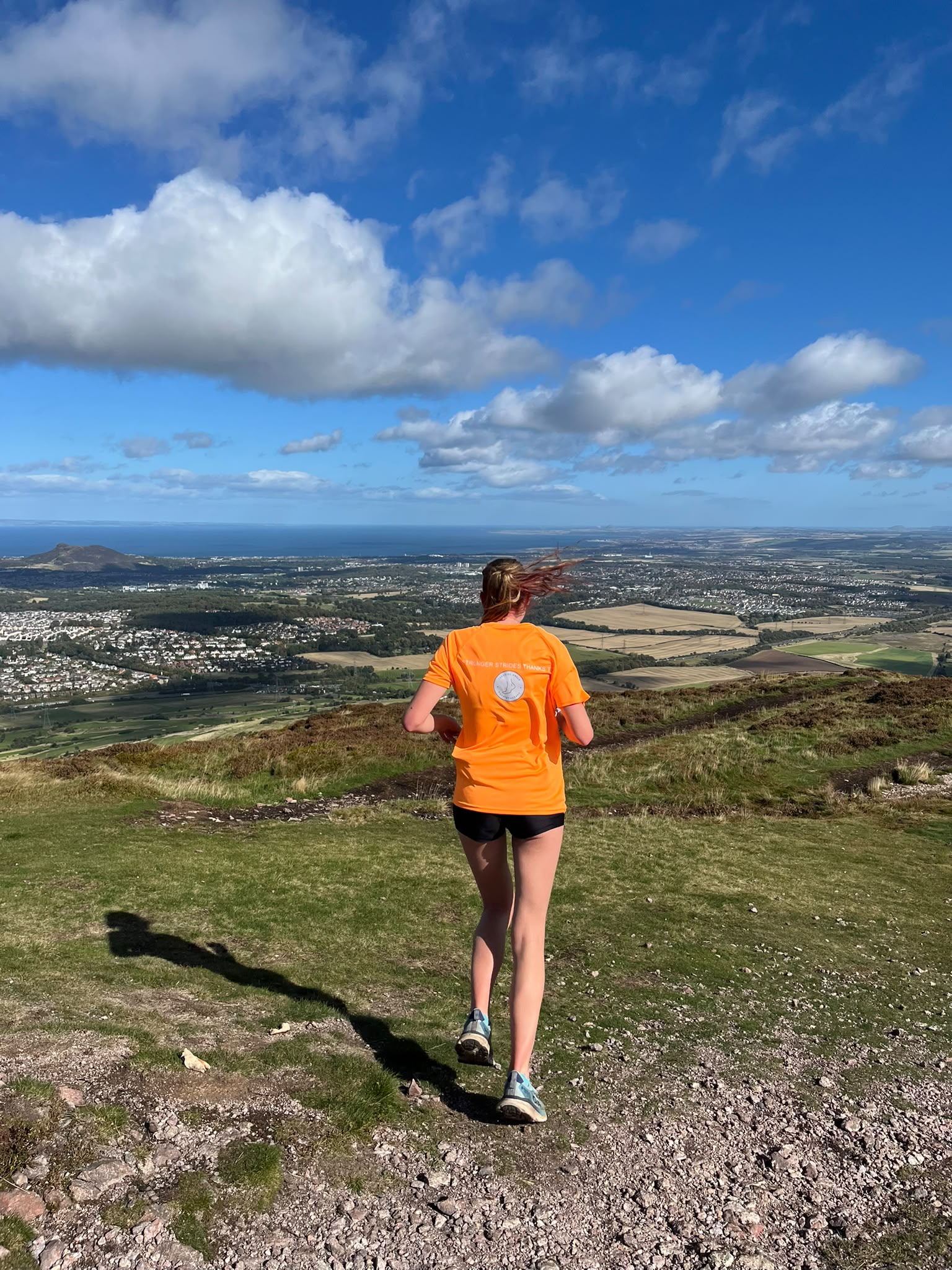 Runner heading downhill on a coastal trail after recovering from an ankle sprain